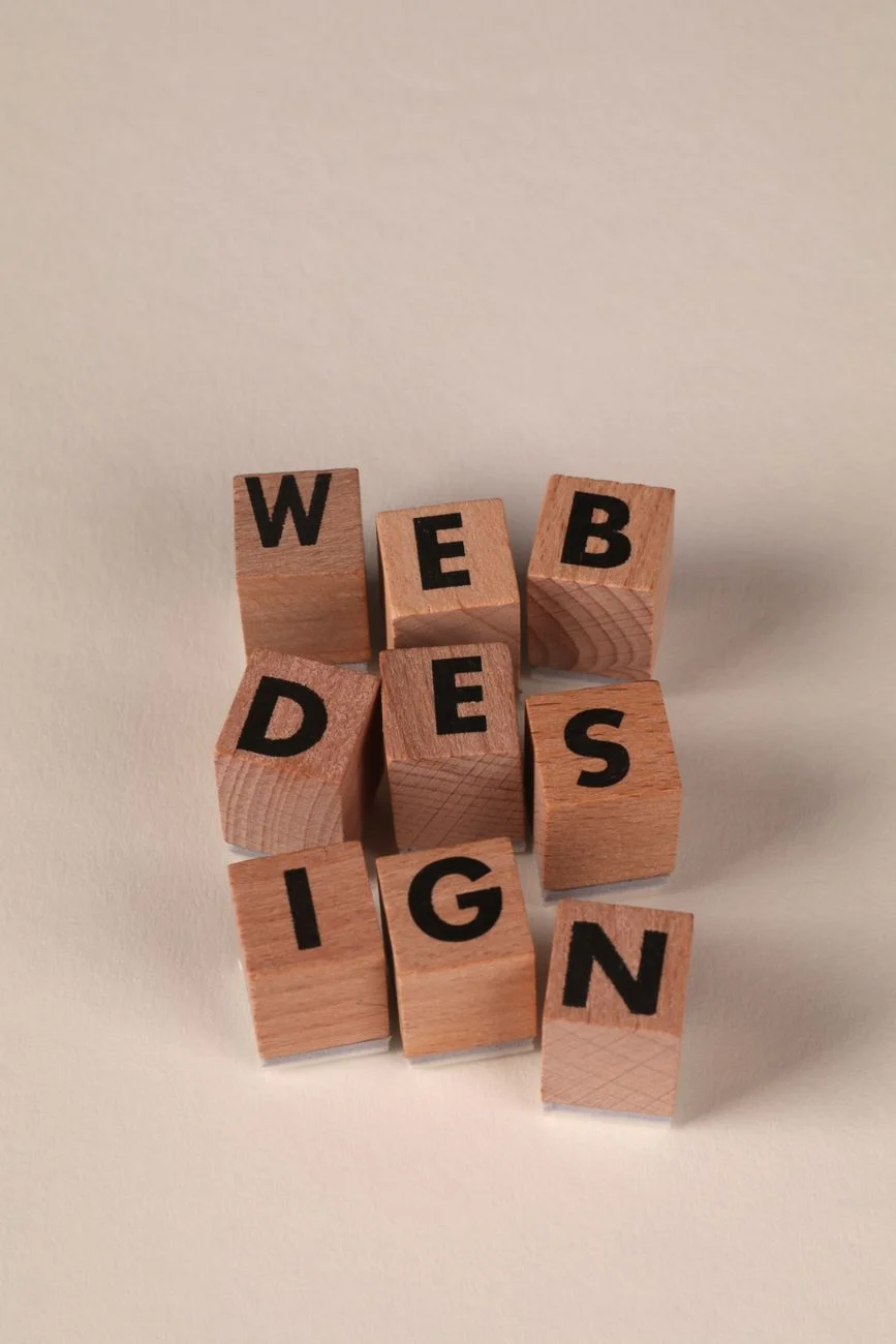 Wooden blocks arranged to spell 'Web Design'. Perfect for creative, digital content themes.
